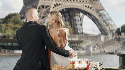 Romantic elegant couple on date at tower. Action. Luxurious elegant couple on date in Paris. Couple...