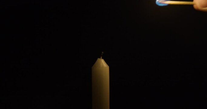 Lighting Single Candle in the dark