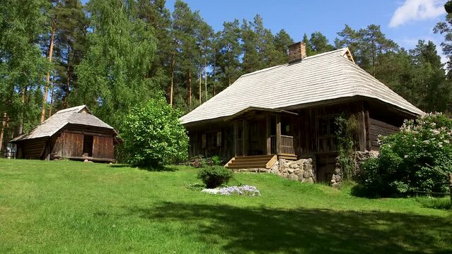 static wide shot of a courtyard in the forest with historic buildings