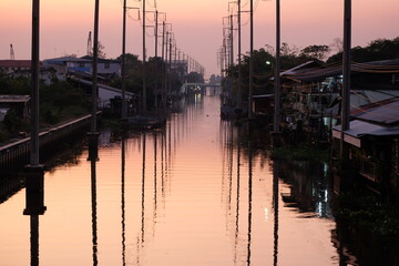 The atmosphere of the wooden houses along the canal in Bangkok in the evening looks as far as the eye can see.