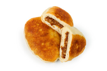 Fried pies with dried fruit on a white background. Whole and cut pie. You can see the filling.