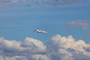 Small transportation plane fly on cloudy sky