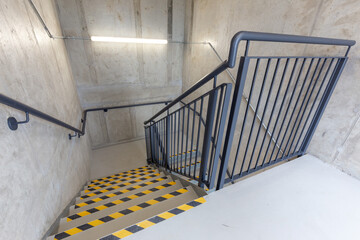 Multi-flight stairway with stainless handrails. FIRE ESCAPE. EMERGENCY EXIT. FIRE EXIT. High...