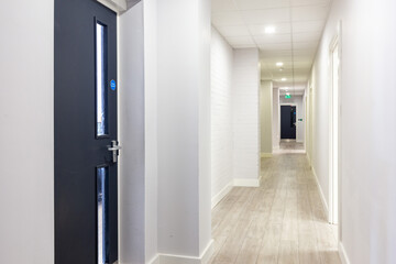 Hallway with blue doors storage units. Concrete floor