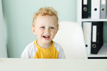 portrait of a happy child. 3-year-old blond boy smiling