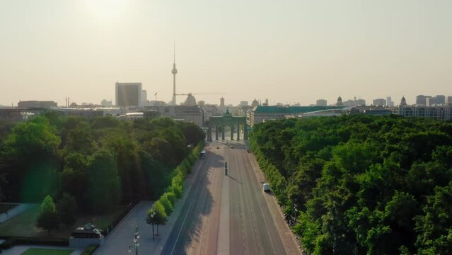 Aerial view of Berlin Skyline with Brandenburg City Gate. Main touristic landmarks of German capital cityscape with TV tower and Tiergarten. Scenic 4K drone zoom in establishing shot in summer morning