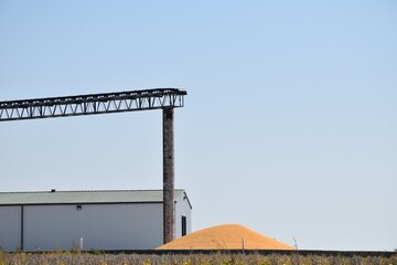 Pile of Corn by a Grain Elevator