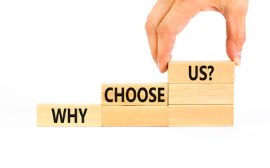Why choose us symbol. Concept word Why choose us on beautiful wooden block. Businessman hand....