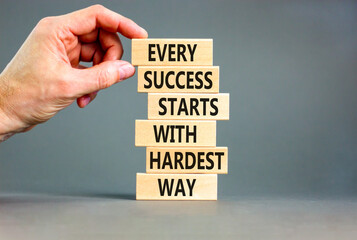 Success symbol. Concept words Every success starts with hardest way on wooden block. Beautiful grey table grey background. Businessman hand. Business success and hardest way concept. Copy space.