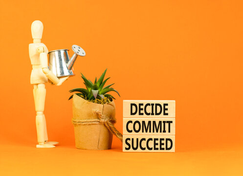 Decide commit succeed symbol. Concept word Decide Commit Succeed on beautiful wooden block. Businessman model. Beautiful orange table background. Business decide commit succeed concept. Copy space.