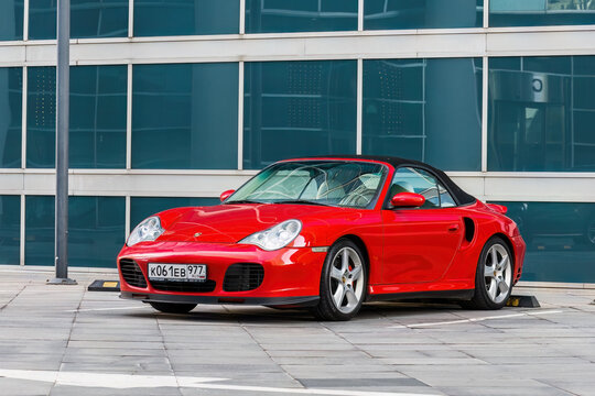 Porsche 911 (996) Turbo Cabriolet car parked in front of modern glass building facade