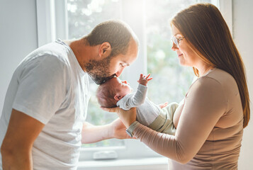 Fototapeta premium father and mother on bedroom with his newborn baby son