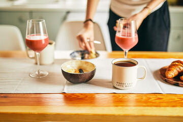 Elegant breakfast spread on a table featuring coffee, croissants, oatmeal with blueberries, and assorted juices. A perfect blend of taste and aesthetics.