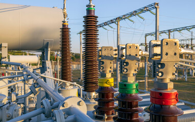 Converter transformer with ceramic insulators and bushings at a substation. - obrazy, fototapety, plakaty