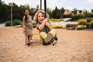 portrait of happy little boy playing with zip line in playground © Marko Domka
