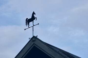silhouette of weathercock with horse figure
