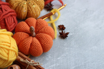 Cozy autumn crochet. Close  up photo of handmade amigurumi toys made of natural yarn. Cute decorations for autumn holidays. Hobbies and leisure concept. 