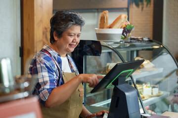 Gray-haired retired elderly business woman receives pension Standing in frontcash register counter,...