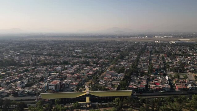 Arial hyperlapse of Central Avenue and Metro in Ecatepec, with Texcoco in the background