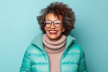 Senior afroamerican woman in warm winter outfit over blue background. Healthy, happy aged lady - obrazy, fototapety, plakaty
