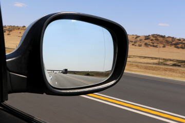 Looking backwards in car side wing mirror, right hand drive, drivers point of view