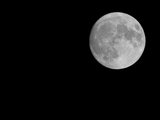 very bright super moon and you can also see the lunar craters with the black sky around