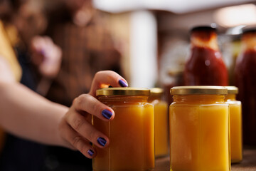 Close up shot of jars full of healthy honey in zero waste shop. Eco friendly produce obtained from ethically kept bees in environmentally friendly local neighborhood store