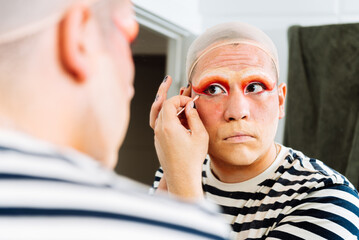 Close up of drag queen applying makeup in dressing room
