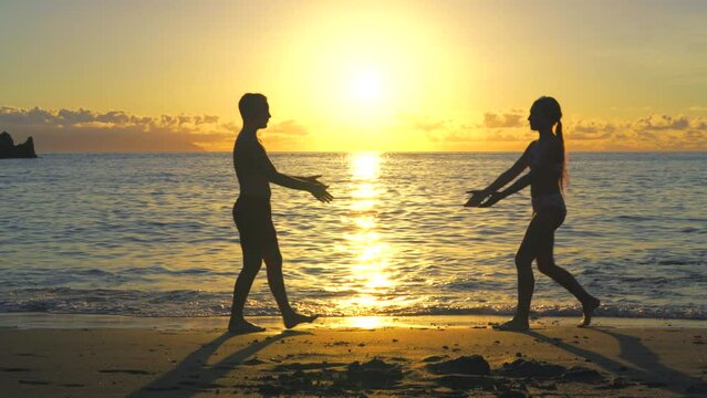 young couple walking on the beach