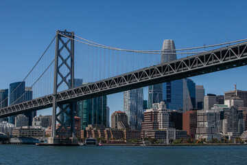 View from water of the San Francisco Bay Bridge in front of the Embarcadero and SF skyline on a clear day