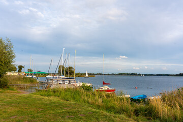 There are boats and yachts on the shore of the lake