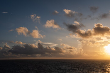 Naklejka na ściany i meble Golden sky over the Caribbean Sea at sunrise/sunset