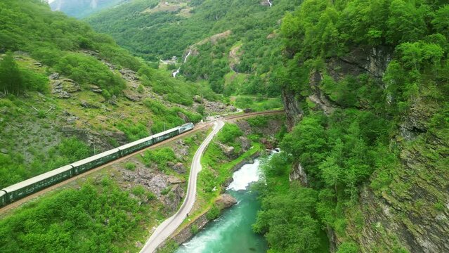 Drone Norway. Flamsbana train on Flam Railway in Flam, Norway. Mountains and waterfalls of Norway in summer. Famous train adventure for cruise ship tourists. 