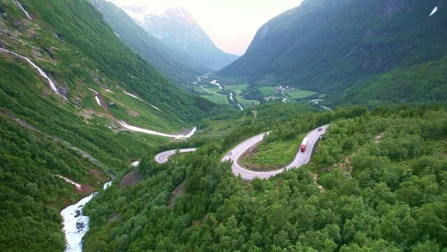 Drone Norway. Car drive on curvy canyon Trollstigen road. Famous scenic drive, Norwegian landmark popular tourism destination. Norway in summer, 4k.  