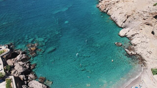 Summer holidays and leisure time at the seashore. Beautiful small Finika Beach Lutro seen from aerial view. Greek sea and beaches. High quality 4k footage