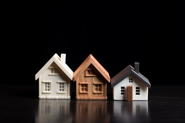 Fototapeta na wymiar Vacation and Secondary Homes Mortgage Concept - Two Miniature Houses Against a Black Background - Created with Generative AI Tools