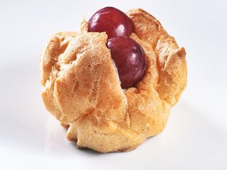 Tokyo, Japan - September 29, 2023: Closeup of cream puff with topping grapes
