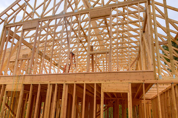 Construction work in progress an unfinished house with wooden framing beams view