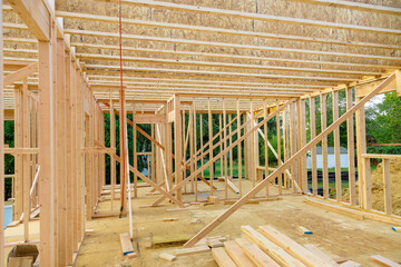 Wooden framing beams an unfinished house construction work in progress view