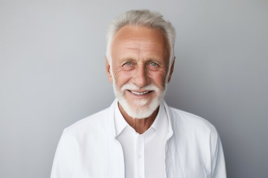 Elderly man with a radiant smile and flawless teeth, ideal for dental promotion. His modern haircut and beard underscore ageless style. Generated with AI.