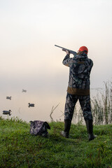 hunter shooting. waterfowl hunter shooting. male hobby.