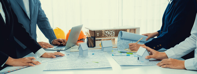 Worker, architect and engineer work on real estate construction project oratory planning with...