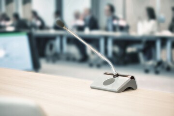 microphone during a meeting with business men and women