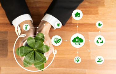 Top view businessman holding plant symbolize environmental protection by corporate ESG commitment...