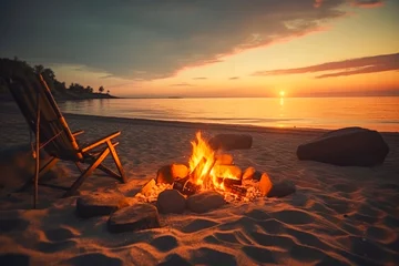Foto auf Acrylglas Sonnenuntergang am Strand Sunset lighting of beach side campfire and bonfire at outdoor lifestyle in background of tent and chair with beautiful sunset. Lifestyle concept for holidays and travel.
