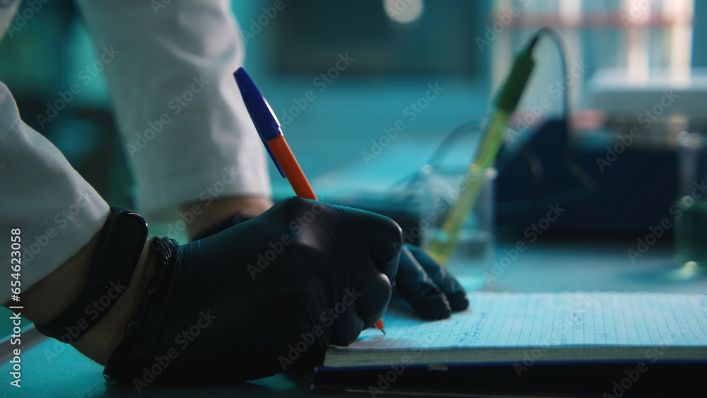 Poster laboratory assistant writes down results in notebook. stock footage. scientist records results of ex