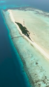 Aerial drone of tropical island on the atoll and coral reef. Timba Timba islet. Tun Sakaran Marine Park. Borneo, Sabah, Malaysia.