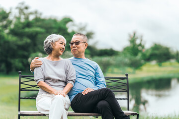 Asian people mature husband and wife, seated on chairs, elderly couple, seated in the park on comfortable chair, deep love and lifelong. Elderly Love Senior Couples, long life togetherness