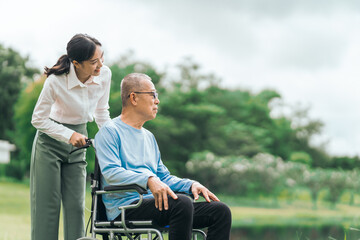 Asian people elderly man on wheelchair with caregiver nurse outdoor, , exemplifying the essence of holistic well-being and compassionate support. Nature Therapy
