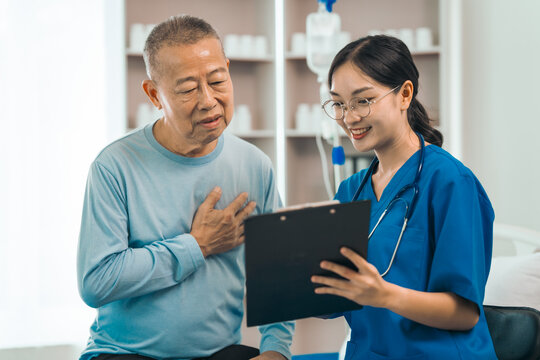 Elderly man engages in thoughtful discussion with compassionate asian people female doctor, addressing health agenda and medical concerns, exemplifying importance of patient-centered care.